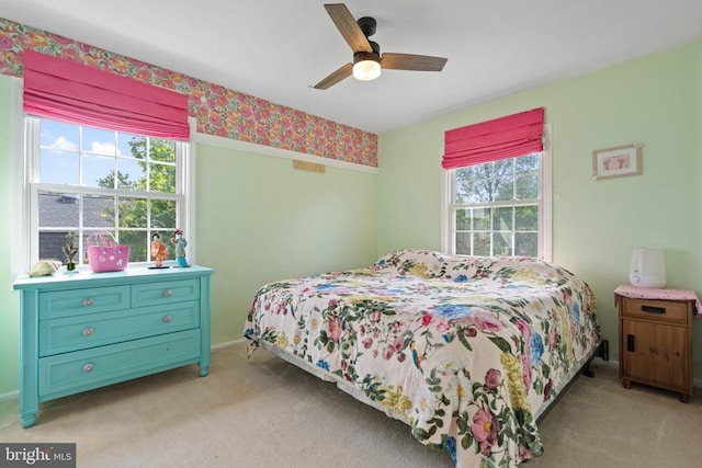  - bedroom with multiple windows, light colored carpet, and a ceiling fan