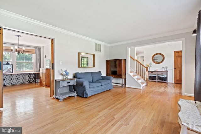  - living room featuring light wood-type flooring, a chandelier, crown molding, and stairway