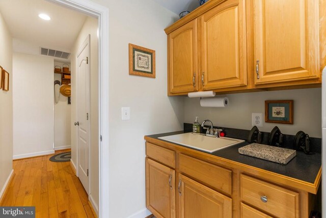 15103 Jenkins Hill Ln, Culpeper, VA 22701 - kitchen with a sink, dark countertops, light wood-type flooring, baseboards, and recessed lighting