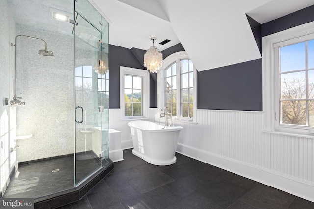  - bathroom featuring a freestanding bath, a shower stall, a wainscoted wall, a chandelier, and lofted ceiling