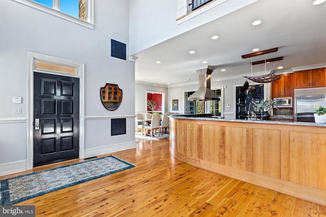  - entrance foyer featuring crown molding, light wood-style flooring, plenty of natural light, recessed lighting, and baseboards