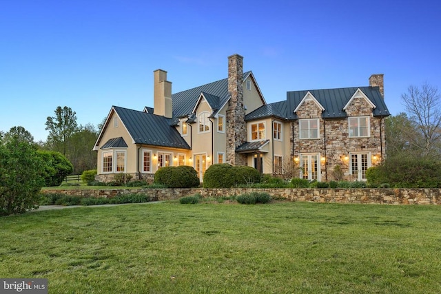  - view of front facade with a standing seam roof, a chimney, and metal roof