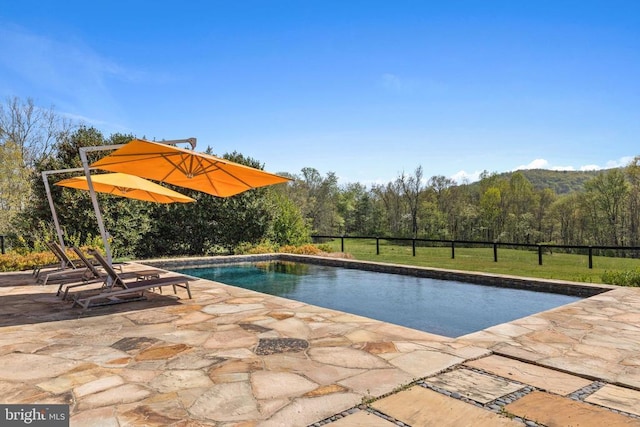  - outdoor pool with a patio and a view of trees