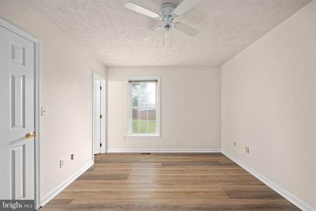 11810 Falcon Ridge Dr, Fredericksburg, VA 22407 - empty room featuring a textured ceiling, ceiling fan, wood finished floors, and baseboards
