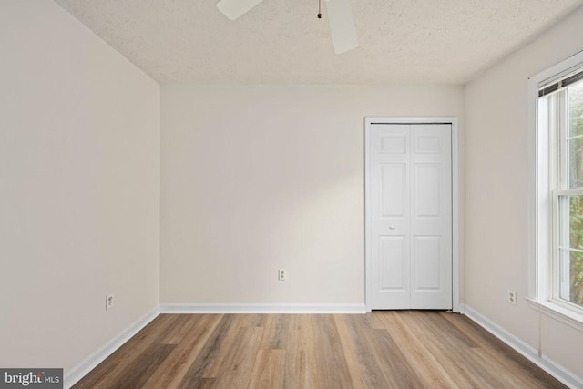 11810 Falcon Ridge Dr, Fredericksburg, VA 22407 - unfurnished bedroom with wood finished floors, a textured ceiling, baseboards, a closet, and ceiling fan