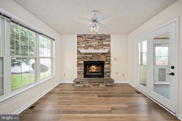11810 Falcon Ridge Dr, Fredericksburg, VA 22407 - unfurnished living room featuring a textured ceiling, healthy amount of natural light, wood finished floors, and ceiling fan