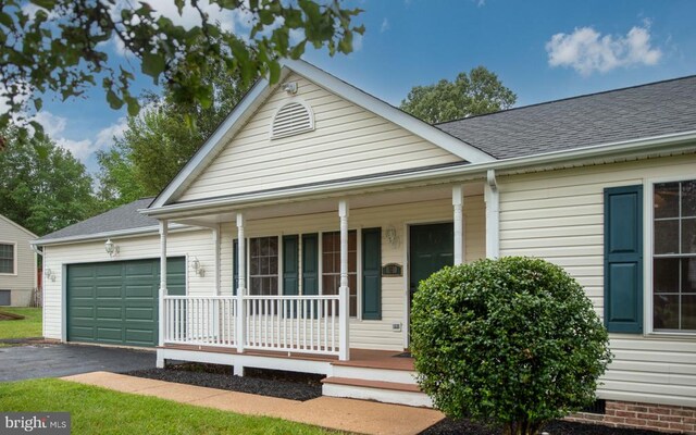 11810 Falcon Ridge Dr, Fredericksburg, VA 22407 - view of front of property with a porch, an attached garage, driveway, and roof with shingles
