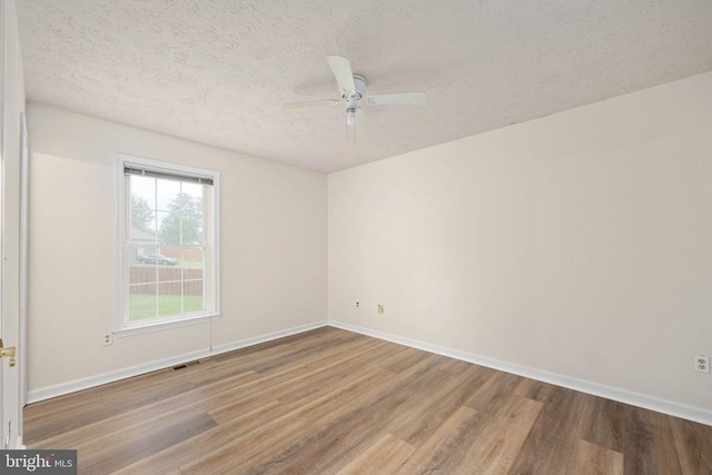 11810 Falcon Ridge Dr, Fredericksburg, VA 22407 - spare room with wood finished floors, a textured ceiling, a ceiling fan, and baseboards