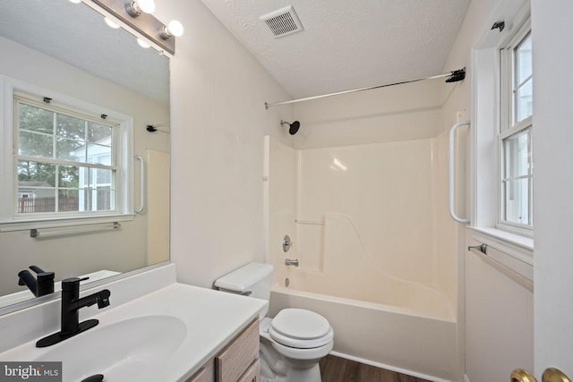 11810 Falcon Ridge Dr, Fredericksburg, VA 22407 - full bathroom featuring toilet, vanity, bathing tub / shower combination, a textured ceiling, and wood finished floors