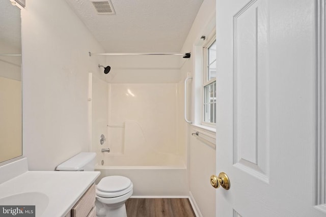 11810 Falcon Ridge Dr, Fredericksburg, VA 22407 - bathroom with vanity, toilet, a textured ceiling,  shower combination, and wood finished floors