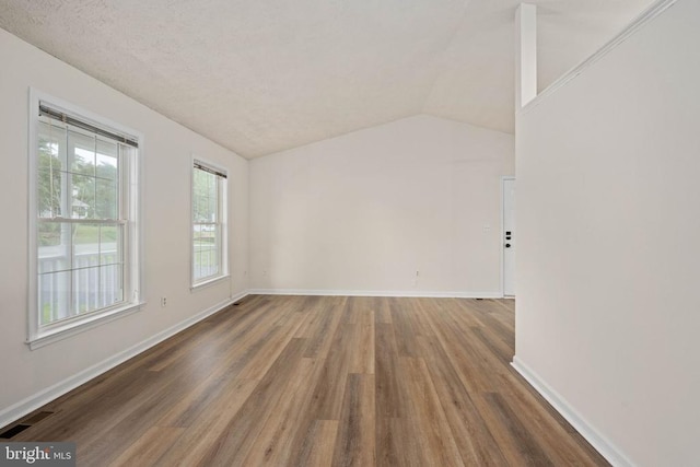 11810 Falcon Ridge Dr, Fredericksburg, VA 22407 - spare room featuring wood finished floors, vaulted ceiling, and baseboards