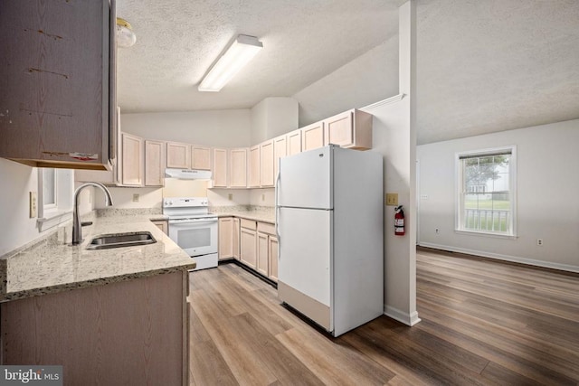 11810 Falcon Ridge Dr, Fredericksburg, VA 22407 - kitchen with white appliances, a sink, vaulted ceiling, under cabinet range hood, and light stone countertops