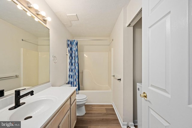 11810 Falcon Ridge Dr, Fredericksburg, VA 22407 - bathroom with toilet, vanity, wood finished floors, a textured ceiling, and shower / bathtub combination with curtain
