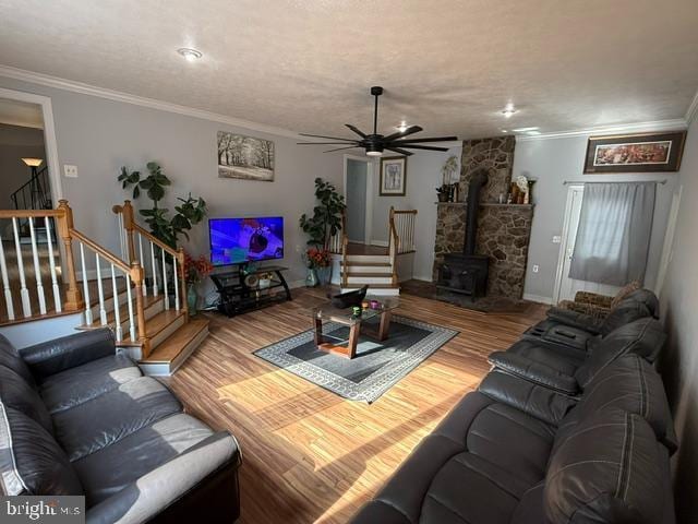 11223 Beales Branch Ln, Remington, VA 22734 - living area featuring ornamental molding, stairs, a wood stove, and wood finished floors