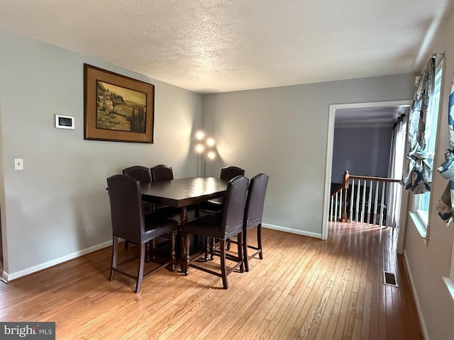11223 Beales Branch Ln, Remington, VA 22734 - dining room featuring a textured ceiling, baseboards, and hardwood / wood-style floors