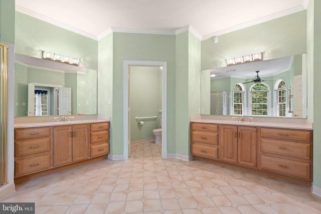  - full bathroom featuring toilet, a sink, two vanities, crown molding, and ceiling fan