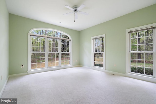  - carpeted empty room featuring ceiling fan and baseboards