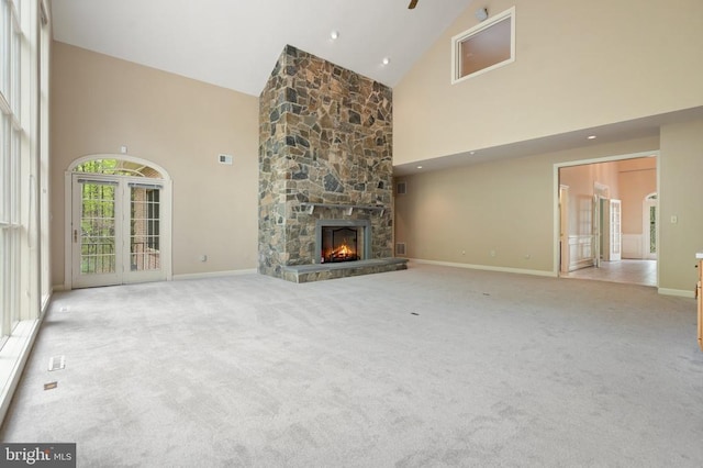  - unfurnished living room featuring baseboards, carpet flooring, and high vaulted ceiling