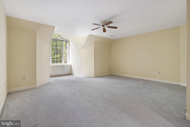  - additional living space with ceiling fan, lofted ceiling, light colored carpet, and baseboards