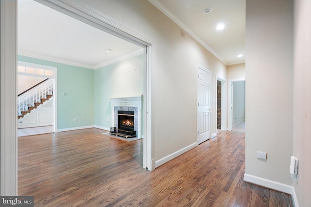  - unfurnished living room with baseboards, ornamental molding, and wood finished floors