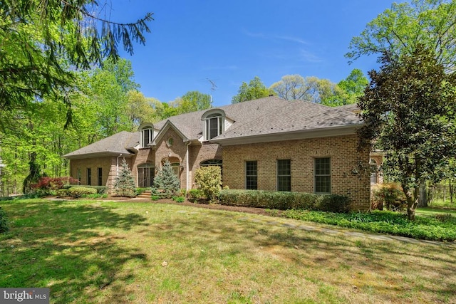  - french provincial home featuring brick siding and a front yard