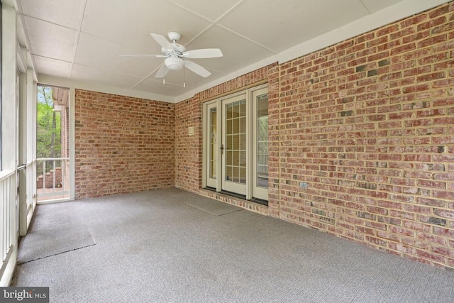  - unfurnished sunroom featuring ceiling fan
