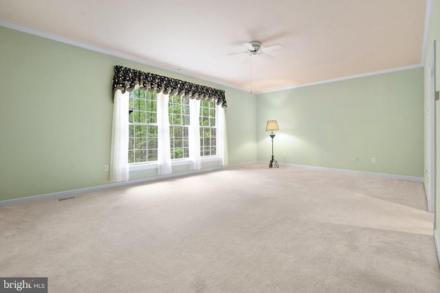  - unfurnished room with crown molding, carpet, baseboards, and a ceiling fan