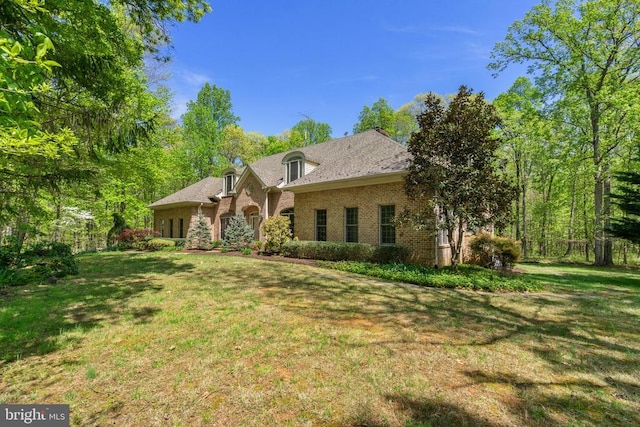 - back of house featuring a yard and brick siding