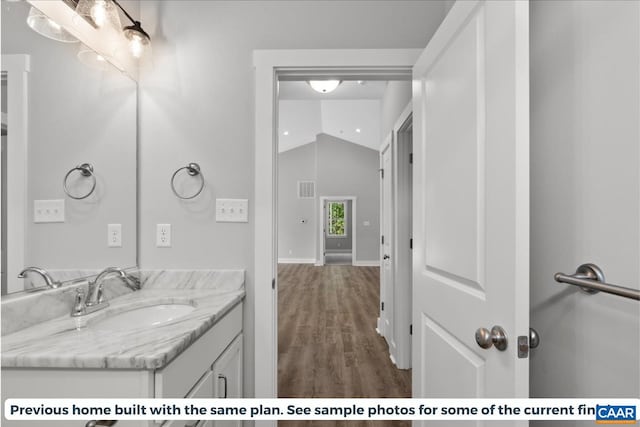 TBD Piney Green Road, Crewe, VA 23930 - bathroom featuring wood finished floors, vanity, visible vents, vaulted ceiling, and baseboards