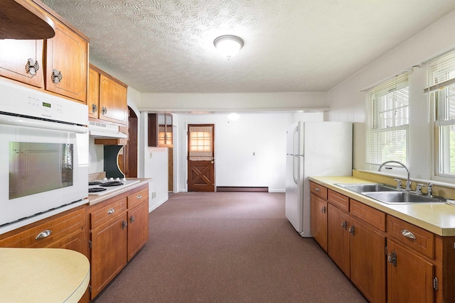 4056 E Point Rd, Elkton, VA 22827 - kitchen with a sink, white appliances, a baseboard radiator, light countertops, and light colored carpet