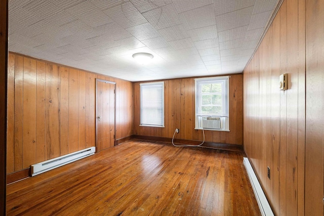 4056 E Point Rd, Elkton, VA 22827 - empty room with baseboard heating, hardwood / wood-style flooring, cooling unit, and wood walls