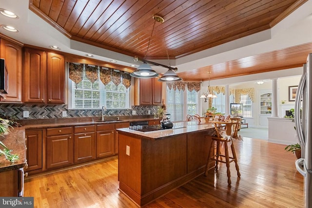 11918 Boulder Ct, Spotsylvania, VA 22553 - kitchen featuring crown molding, wooden ceiling, freestanding refrigerator, a kitchen breakfast bar, and backsplash