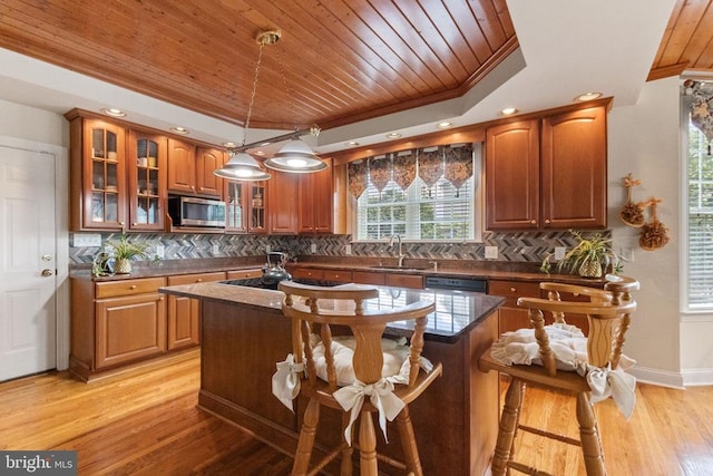 11918 Boulder Ct, Spotsylvania, VA 22553 - kitchen with stainless steel microwave, crown molding, wood ceiling, a kitchen island, and a kitchen bar