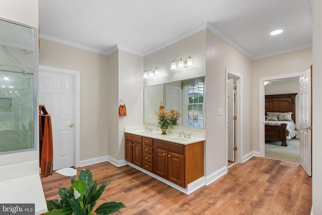 11918 Boulder Ct, Spotsylvania, VA 22553 - bathroom with wood finished floors, double vanity, connected bathroom, ornamental molding, and a marble finish shower
