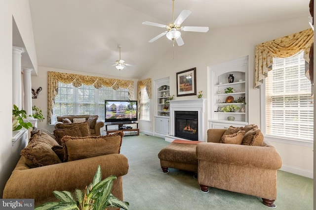 11918 Boulder Ct, Spotsylvania, VA 22553 - living room featuring a glass covered fireplace, carpet flooring, a ceiling fan, built in shelves, and vaulted ceiling
