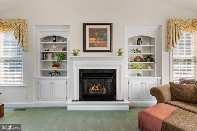 11918 Boulder Ct, Spotsylvania, VA 22553 - carpeted living area with a warm lit fireplace, built in features, and vaulted ceiling