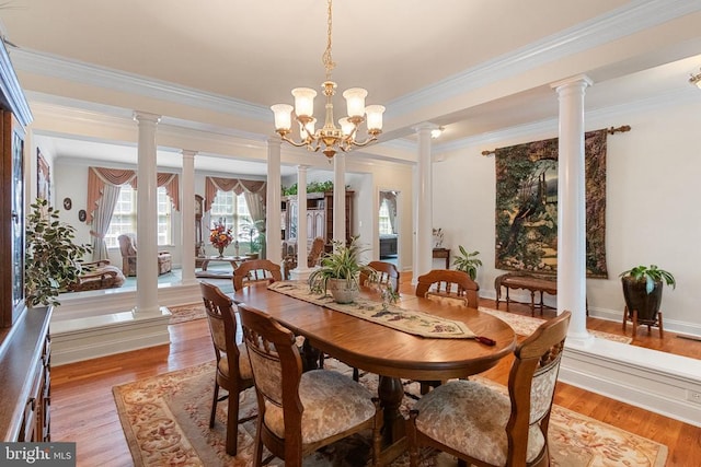 11918 Boulder Ct, Spotsylvania, VA 22553 - dining area featuring ornamental molding, ornate columns, light wood-type flooring, and a chandelier