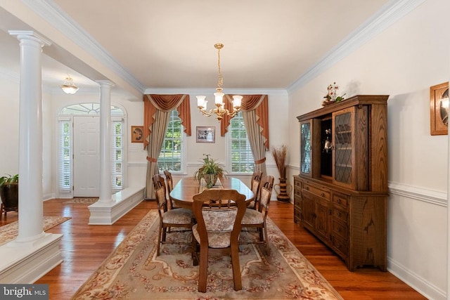 11918 Boulder Ct, Spotsylvania, VA 22553 - dining room featuring wood finished floors, ornamental molding, a chandelier, and decorative columns