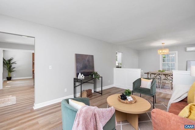 1601 Antoinette Ave, Charlottesville, VA 22903 - living area featuring wood finished floors, a chandelier, and a wall mounted AC