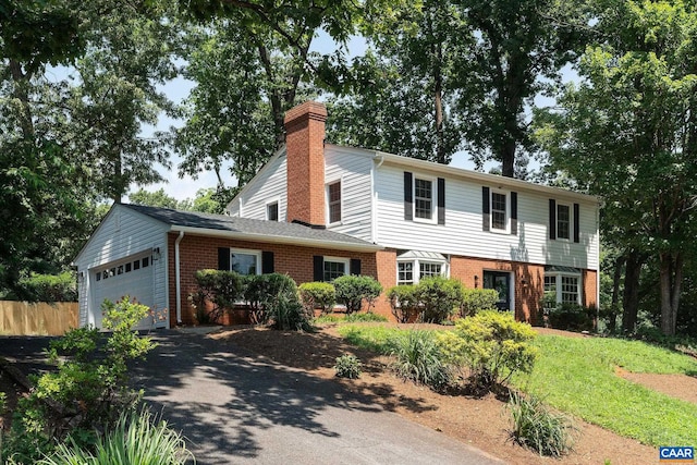 1601 Antoinette Ave, Charlottesville, VA 22903 - view of front of home featuring brick siding, driveway, a chimney, and a garage