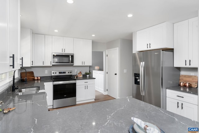 1601 Antoinette Ave, Charlottesville, VA 22903 - kitchen with stainless steel appliances, dark stone counters, white cabinetry, and recessed lighting