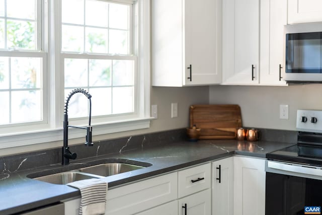 1601 Antoinette Ave, Charlottesville, VA 22903 - kitchen featuring stainless steel appliances, white cabinetry, and dark countertops
