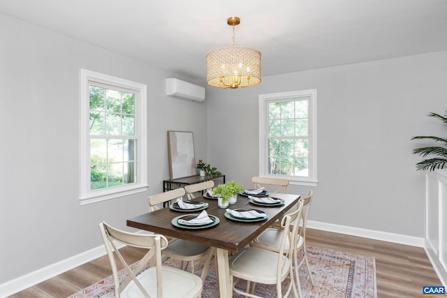 1601 Antoinette Ave, Charlottesville, VA 22903 - dining room featuring an AC wall unit, plenty of natural light, a chandelier, and light wood-type flooring