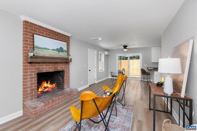 1601 Antoinette Ave, Charlottesville, VA 22903 - living room with a brick fireplace, wood finished floors, ceiling fan, and a wall mounted air conditioner