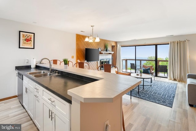 1545 Cliffs, Roseland, VA 22967 - kitchen featuring a sink, open floor plan, a chandelier, stainless steel dishwasher, and a peninsula