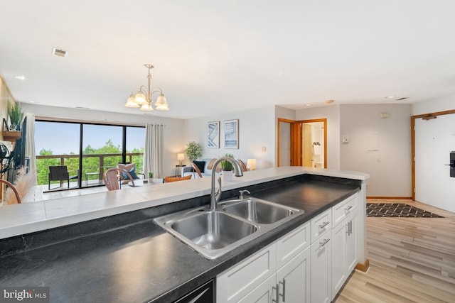 1545 Cliffs, Roseland, VA 22967 - kitchen with a sink, dark countertops, white cabinetry, a chandelier, and recessed lighting