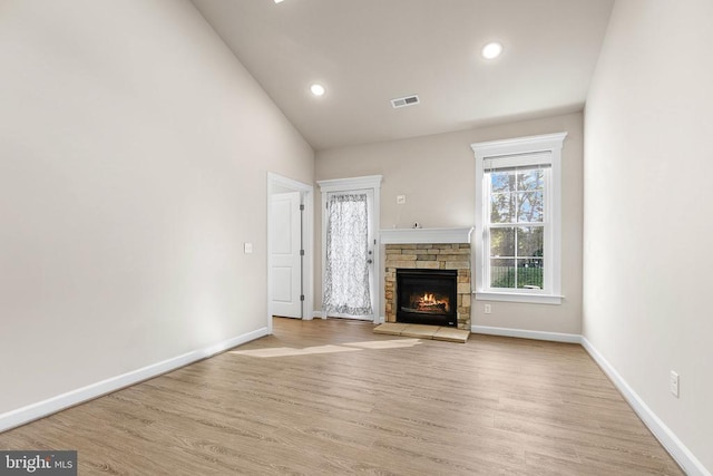 5711 Finley Rose Ct, Fredericksburg, VA 22407 - unfurnished living room with wood finished floors, vaulted ceiling, a lit fireplace, and recessed lighting