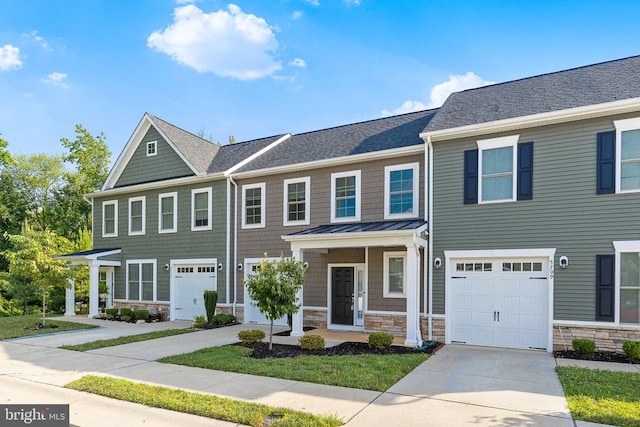 5711 Finley Rose Ct, Fredericksburg, VA 22407 - townhome / multi-family property featuring stone siding, driveway, a standing seam roof, and roof with shingles