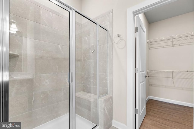5711 Finley Rose Ct, Fredericksburg, VA 22407 - full bathroom with a stall shower, a spacious closet, and wood finished floors