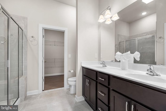 5711 Finley Rose Ct, Fredericksburg, VA 22407 - bathroom featuring a shower stall, double vanity, and a walk in closet